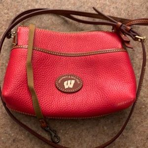 UW Dooney & Bourke purse. Adjustable strap. Three separate pockets. New!